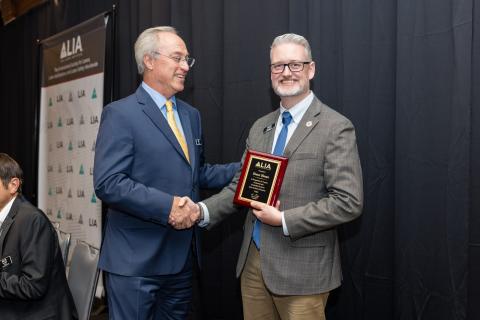 Shaun Oleson Receiving Plaque from Gilbert Haas