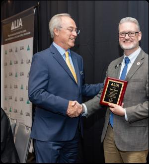 Shaun Oleson Receiving Plaque from Gilbert Haas